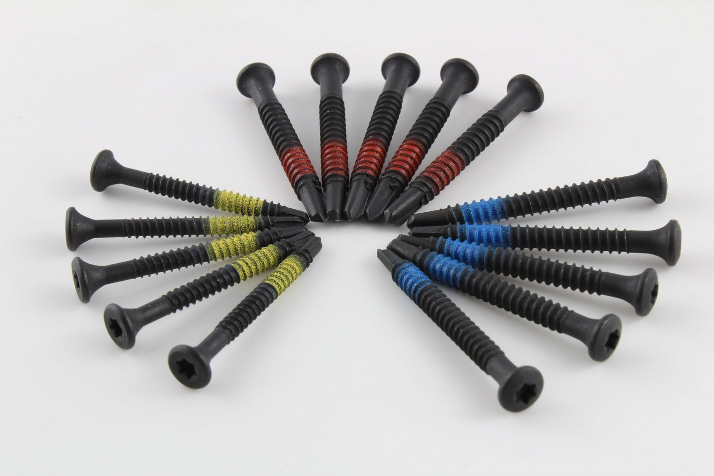 Lokko extraction screws fanned together with red, blue, and yellow size bands visible