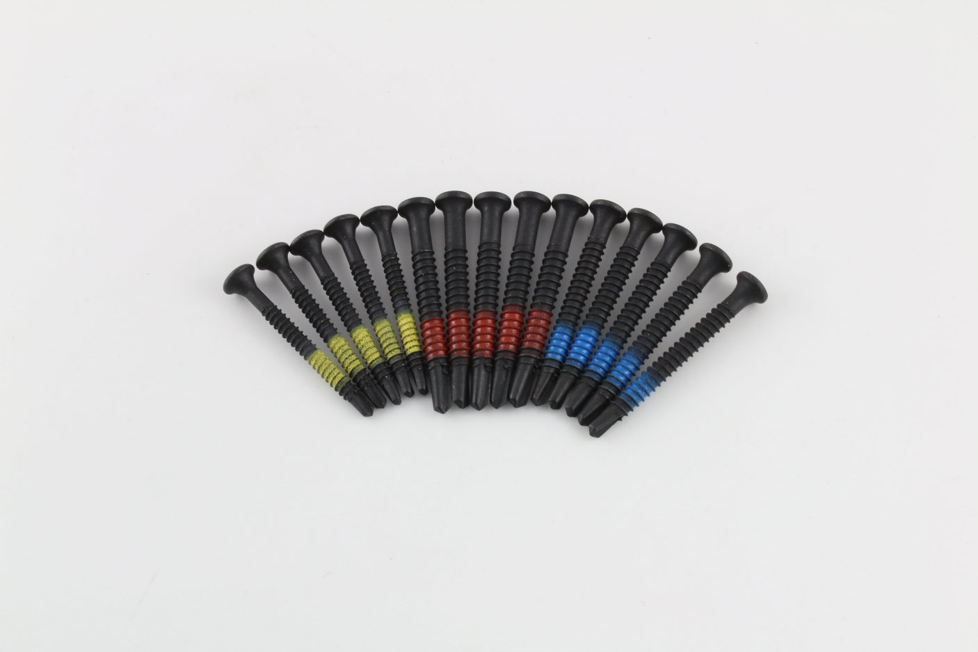 Fan of Lokko self-tapping screws grouped by yellow, red, and blue thread bands