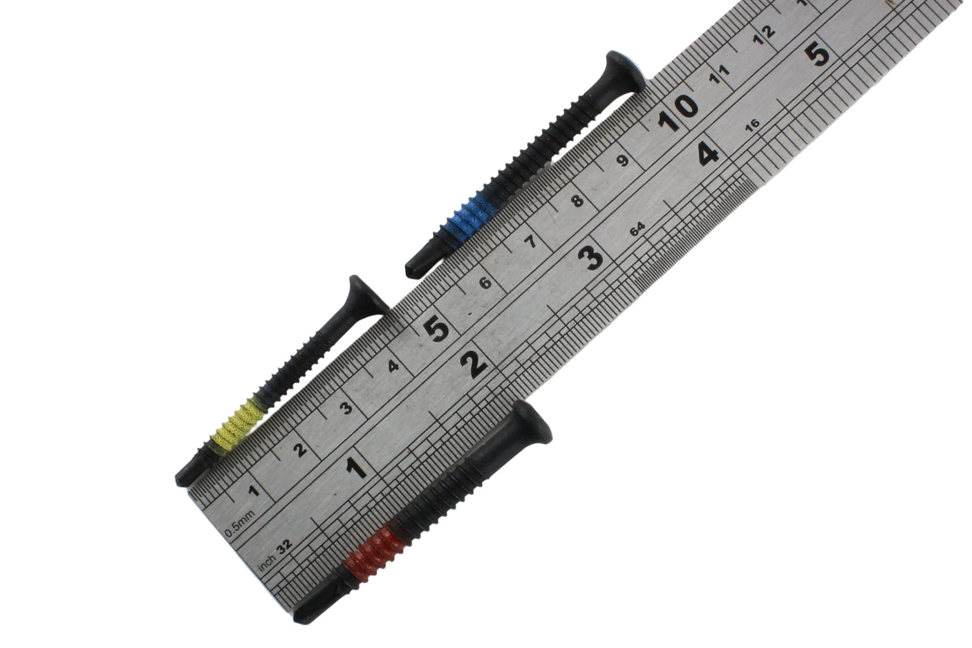 Three Lokko plug puller screws laid across a steel ruler, each around four to five centimetres long