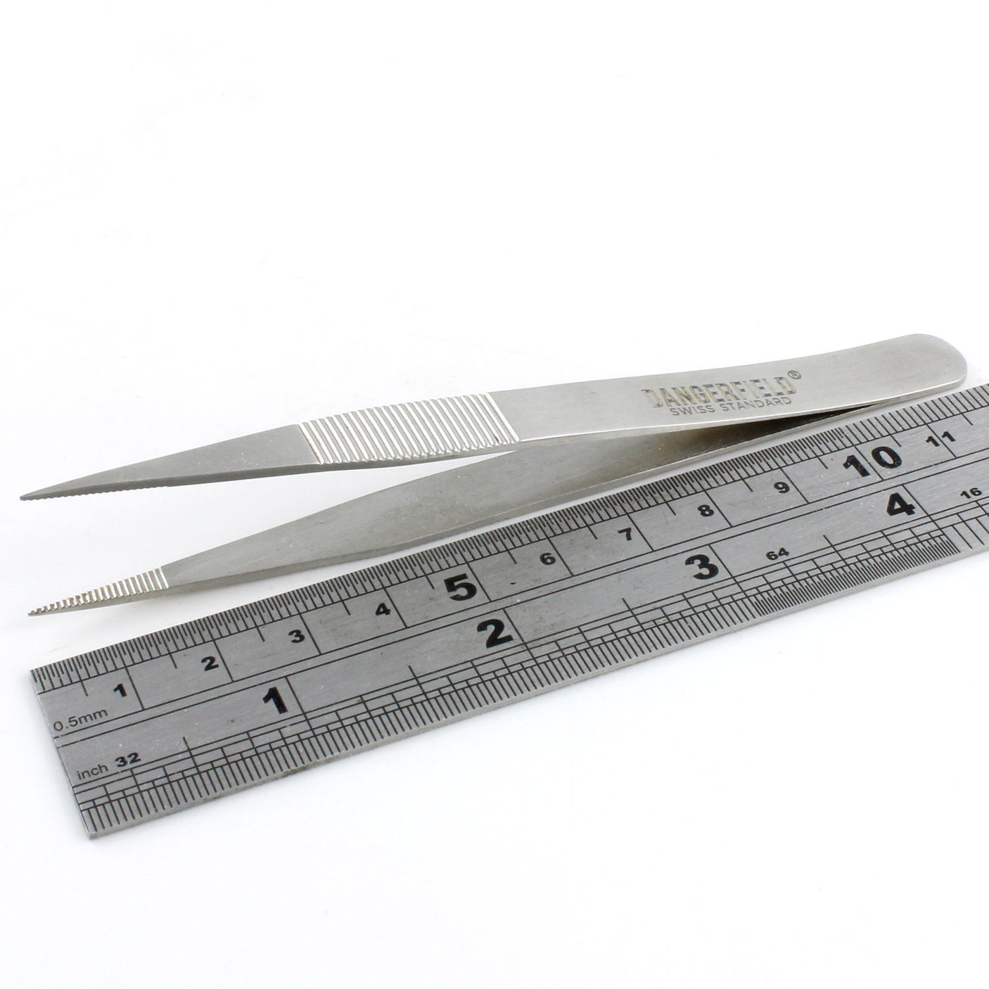 Side view of Dangerfield repinning tweezers next to a ruler for scale