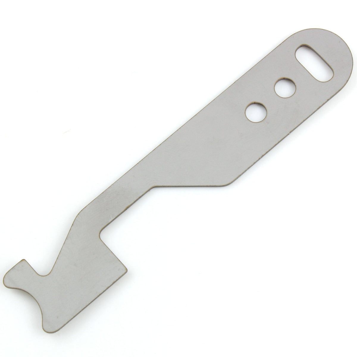 Close view of the Lokko shove-knife working end showing the stepped hooked tip cut into flat stainless steel