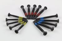 Lokko extraction screws fanned together with red, blue, and yellow size bands visible