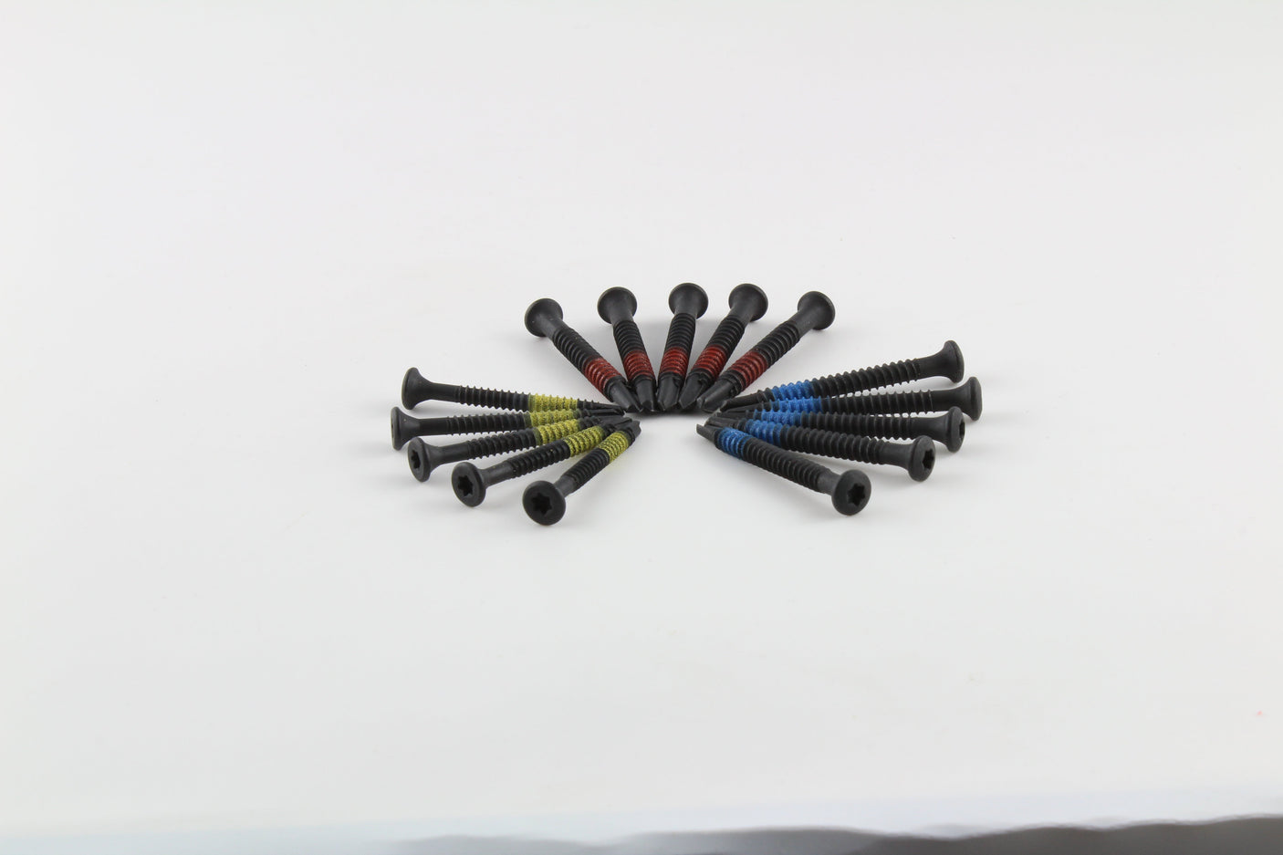 Colour-coded Lokko self-tapping pull-screws laid out for a clear view of the threads