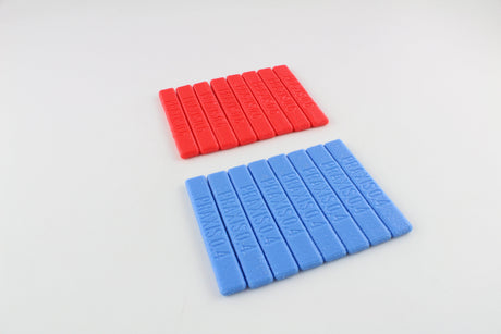 Sixteen Dangerfield Praxis grip handles in two rows, red handles marked PRAXIS 0.6 and blue handles marked PRAXIS 0.4