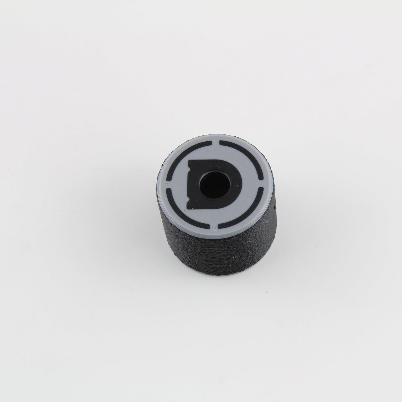 Top view of the bump key dampener showing the grey cap, central keyway slot and Dangerfield D logo