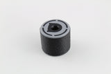 Angled three-quarter view of the black rubber bump key dampener standing on its base