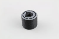 Angled three-quarter view of the black rubber bump key dampener standing on its base