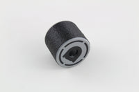 Studio view of the black rubber bump key dampener with its moulded grey cap