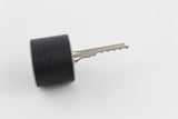 Bump key seated in the rubber dampener with the cut blade exposed, ready to slide into a cylinder