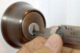 Lishi KW1 pick being guided into a residential Kwikset cylinder