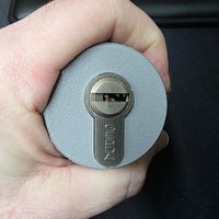Hand holding the Lokko euro cylinder hand support with a euro profile cylinder seated in the socket