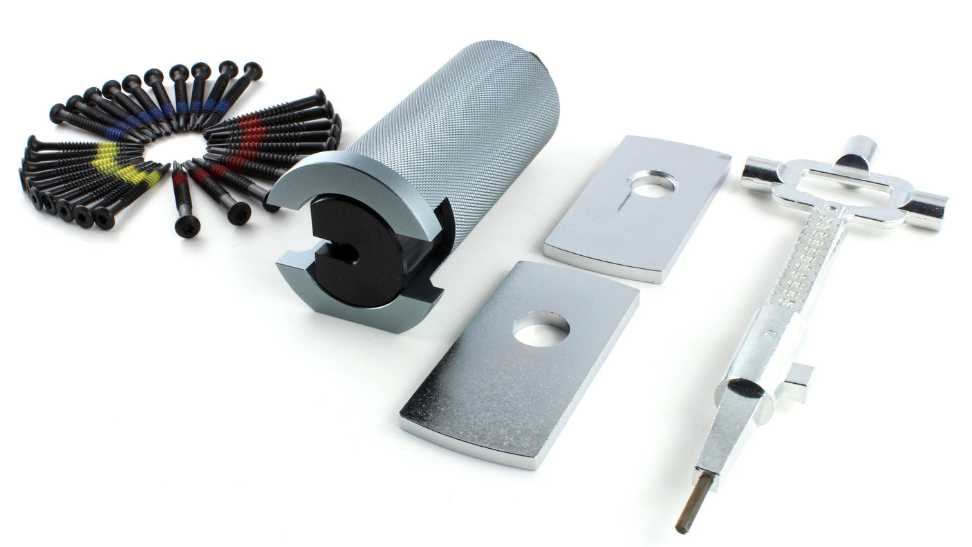 Wide layout of the Lokko bell plug puller kit parts, bell puller, protection plates, screws, and cam turner in a row