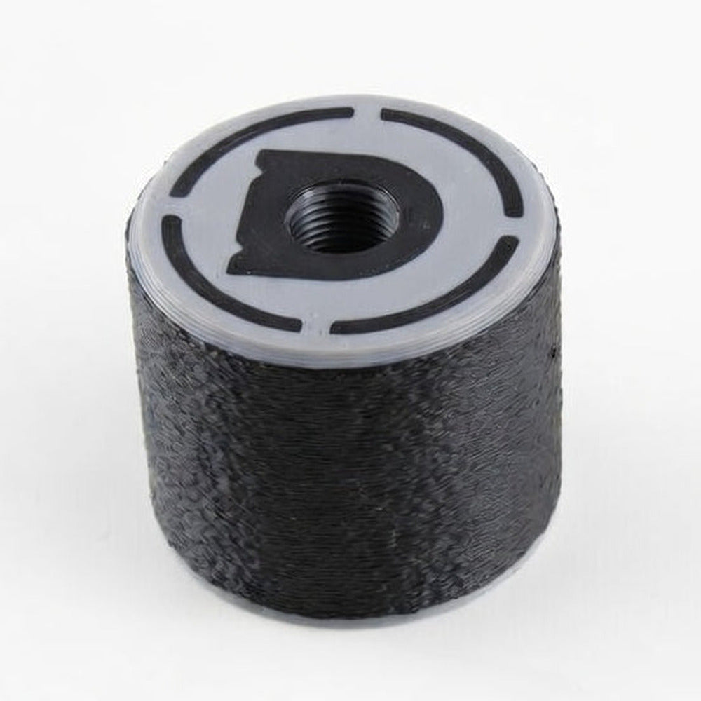 Professional Bump Assist Tool, black rubber bump key dampener with a grey moulded cap, threaded hole and Dangerfield D logo, top view