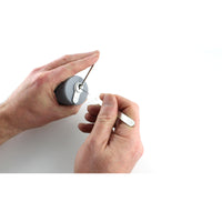 Close view of a euro cylinder held in the Lokko hand support while being picked, keyway and tension tool in frame