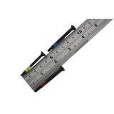 Three Lokko plug puller screws laid across a steel ruler, each around four to five centimetres long