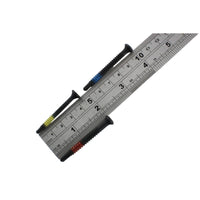 Three Lokko plug puller screws laid across a steel ruler, each around four to five centimetres long