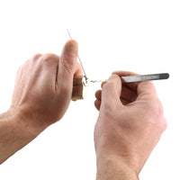 Hands using lock pick rakes from Dangerfield Polaris to manipulate a lock.